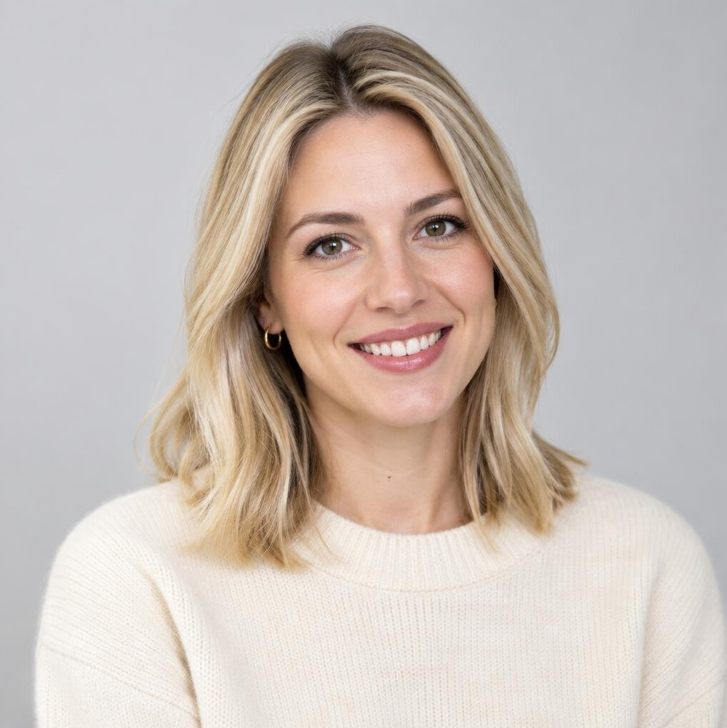 Portrait of a smiling young woman in a cream sweater