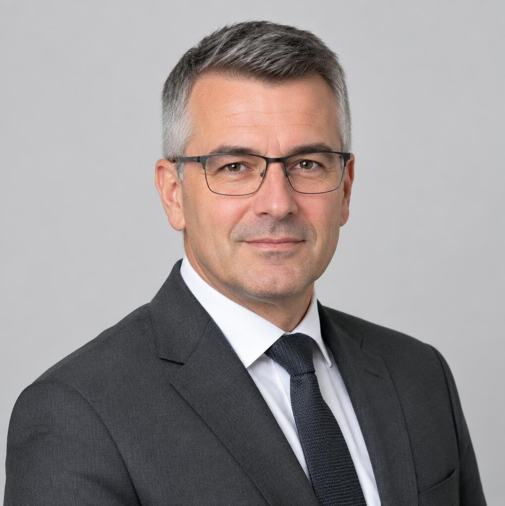 Portrait of a man with glasses in a suit jacket