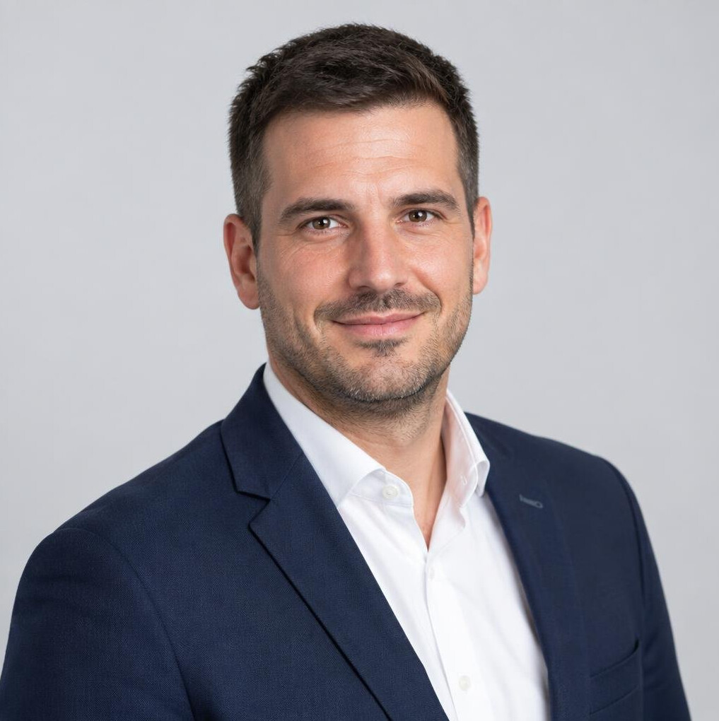 Portrait of a smiling man in a navy blazer